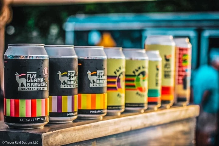 Sign up to be a vendor at Llamapalooza - Beer lined up on a shelf